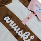 "Room 304" pique cotton polo by WUUSKÎ — lifestyle detail shot