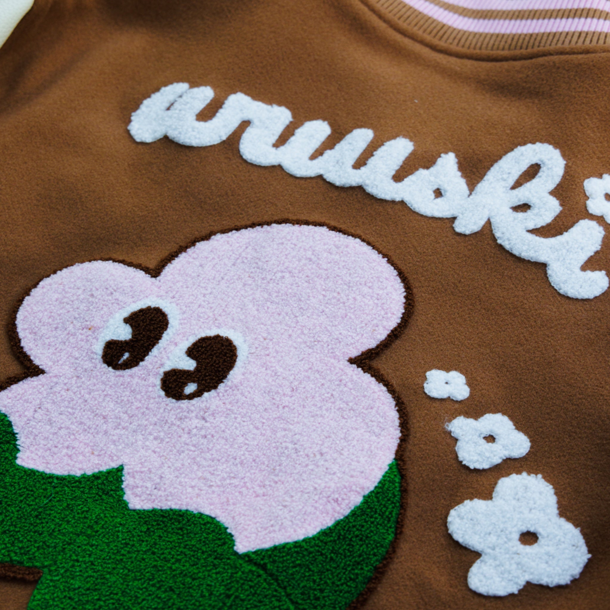 "Wuuskî Unîversity" letterman jacket by WUUSKÎ — lifestyle shot, Atlanta streetwear