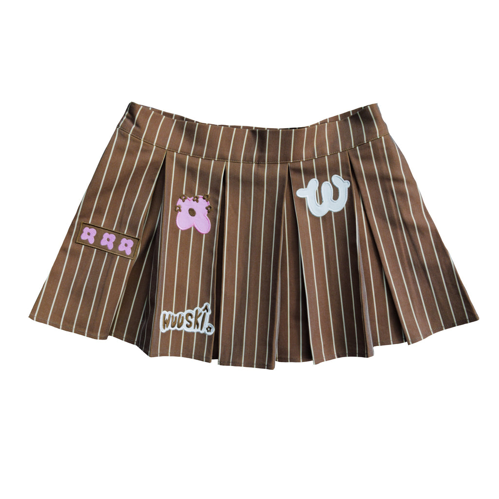 "Unîversity" pleated mini skort by WUUSKÎ — model wearing, polyester/rayon blend
