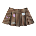 "Unîversity" pleated mini skort by WUUSKÎ — model wearing, polyester/rayon blend