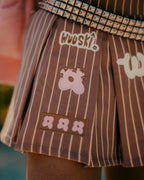 "Unîversity" pleated skort by WUUSKÎ — lifestyle, flower-inspired brand