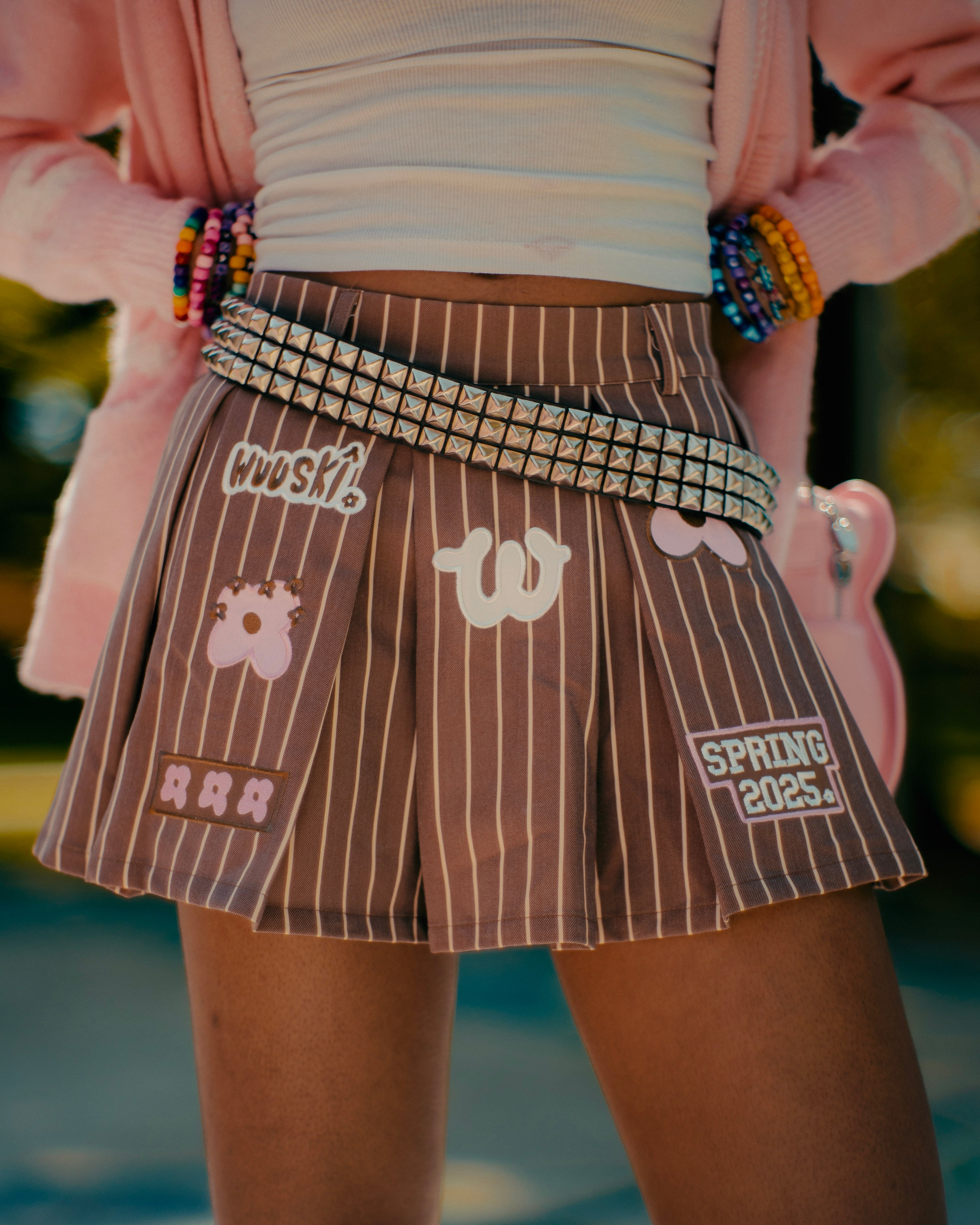 "Unîversity" pleated mini skort by WUUSKÎ — lifestyle editorial